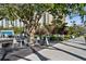Inviting outdoor dining area with tables, chairs, and nearby shade trees at 750 N Tamiami Trl # 407, Sarasota, FL 34236