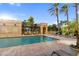 Resort-style pool area features tropical landscaping and comfortable lounge seating with clear blue skies at 750 N Tamiami Trl # 407, Sarasota, FL 34236