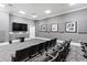 Well-equipped theater room featuring comfortable seating, a large screen, and acoustic panels at 750 N Tamiami Trl # 407, Sarasota, FL 34236
