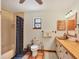 Bright bathroom featuring terracotta tile floors, white cabinets, and a shower-tub combo at 7717 27Th W Ave, Bradenton, FL 34209