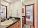 Bright bathroom featuring a sink with wood cabinetry and doorway leading into an adjacent bedroom at 7717 27Th W Ave, Bradenton, FL 34209