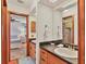 Bathroom featuring a single sink with wood cabinetry and doorway leading into an adjacent bedroom at 7717 27Th W Ave, Bradenton, FL 34209
