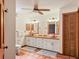 A dual sink bathroom offers white cabinets, wood countertops, and a terracotta tile floor at 7717 27Th W Ave, Bradenton, FL 34209