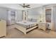 Bright bedroom with neutral carpet, a ceiling fan, and ample natural light at 7717 27Th W Ave, Bradenton, FL 34209