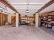 Spacious two-car garage with storage racks and a staircase at 7717 27Th W Ave, Bradenton, FL 34209