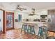 Well-lit kitchen with stainless steel appliances, an island with seating, and access to outdoor patio at 7717 27Th W Ave, Bradenton, FL 34209