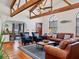 Bright living room featuring vaulted ceilings, wood beams, and a cozy seating area with large windows at 7717 27Th W Ave, Bradenton, FL 34209