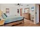 A comfortable main bedroom features a ceiling fan, wood-look flooring, and access to the bathroom at 7717 27Th W Ave, Bradenton, FL 34209