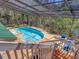 Inviting screened-in pool area with comfortable seating and serene views, perfect for relaxation and outdoor entertainment at 7717 27Th W Ave, Bradenton, FL 34209