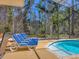 Inviting screened-in pool area with comfortable seating and serene views, perfect for relaxation and outdoor enjoyment at 7717 27Th W Ave, Bradenton, FL 34209