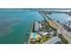 Beautiful aerial view of waterfront condos featuring a community pool and private boat docks on a clear day at 775 John Ringling Blvd # 3, Sarasota, FL 34236