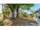 Fenced backyard with mature trees providing shade and privacy for outdoor enjoyment at 8003 Herbison Ave, North Port, FL 34287