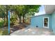Backyard space with a tiled patio area, mature trees and room for outdoor activities at 8003 Herbison Ave, North Port, FL 34287