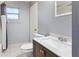 Bathroom featuring neutral gray walls, tile flooring, and a modern vanity with a white countertop at 8003 Herbison Ave, North Port, FL 34287