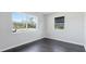 Bright bedroom with hardwood floors and dual windows offering natural light at 8003 Herbison Ave, North Port, FL 34287