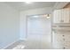Dining room with tiled floors, skylight, and white cabinetry at 8003 Herbison Ave, North Port, FL 34287