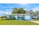 Charming blue single-story home with a well-maintained lawn and a one-car garage at 8003 Herbison Ave, North Port, FL 34287