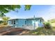 Back exterior view showcasing a paved patio and a tidy yard, ideal for relaxing outdoors at 8003 Herbison Ave, North Port, FL 34287