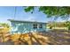 Exterior shot highlighting the home's backyard with its tidy landscaping and surrounding greenery at 8003 Herbison Ave, North Port, FL 34287