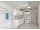 Bright kitchen featuring white cabinets, appliances, and tile flooring at 8003 Herbison Ave, North Port, FL 34287