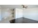 Open-concept living room with hardwood and tile flooring, plus a ceiling fan at 8003 Herbison Ave, North Port, FL 34287