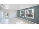 Living room featuring tiled floors, two windows, and a glass door leading to the exterior at 8003 Herbison Ave, North Port, FL 34287