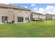 Grassy backyard with a patio area, ideal for enjoying outdoor meals and relaxing near the house at 8850 Christie Dr, Largo, FL 33771