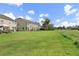 Expansive backyard with a large green lawn, perfect for outdoor activities and relaxation at 8850 Christie Dr, Largo, FL 33771
