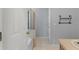 Bathroom featuring a shower with glass doors and a white tiled floor at 8850 Christie Dr, Largo, FL 33771