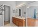 Bathroom with double vanity, large mirror, and lighting, with a view into the bedroom at 8850 Christie Dr, Largo, FL 33771
