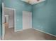 A cozy bedroom featuring a neutral carpet, closet, and a refreshing light blue painted wall at 8850 Christie Dr, Largo, FL 33771