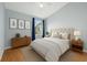 Cozy bedroom featuring hardwood floors, neutral walls, and lots of natural light from the window at 8850 Christie Dr, Largo, FL 33771