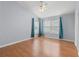 Bedroom with vaulted ceilings, a ceiling fan, and curtains flanking the window at 8850 Christie Dr, Largo, FL 33771