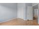 Bedroom with laminate floors, closet, and views of the carpeted hallway at 8850 Christie Dr, Largo, FL 33771