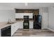 Stylish kitchen with white cabinets, modern appliances, and durable flooring at 8850 Christie Dr, Largo, FL 33771