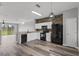 Modern kitchen with black appliances, white cabinetry, and stylish flooring at 8850 Christie Dr, Largo, FL 33771