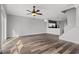 Bright living room featuring wood floors, a ceiling fan, and sliding glass doors to the outside at 8850 Christie Dr, Largo, FL 33771