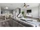 Open-concept living room with modern furnishings, sleek gray floors, and adjacent dining area at 8850 Christie Dr, Largo, FL 33771