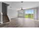 Bright living room with stairs and sliding glass door leading to outdoor space at 8850 Christie Dr, Largo, FL 33771