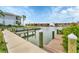 Picturesque dock with wooden posts and a view of waterfront residences, perfect for boating and fishing at 9074 Midnight Pass Rd # 11, Sarasota, FL 34242