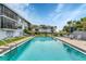 Beautiful community pool surrounded by lush landscaping and lounge seating, offering a resort-style experience at 9074 Midnight Pass Rd # 11, Sarasota, FL 34242