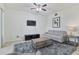 Living room featuring a ceiling fan, television, rug, and neutral color scheme at 915 Fairwaycove Ln # 103, Bradenton, FL 34212