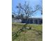 Expansive backyard featuring a well-maintained lawn and a large tree providing ample shade at 935 Shasta Rd, Venice, FL 34293