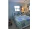 A quaint bedroom with a window, mirror sliding closet doors, and a bed with a decorative quilt at 935 Shasta Rd, Venice, FL 34293