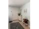 A bright foyer with a patterned area rug, small display table, and cabinet at 935 Shasta Rd, Venice, FL 34293