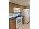 A view of kitchen appliances in a functional kitchen with standard white electric range, refrigerator and microwave at 935 Shasta Rd, Venice, FL 34293