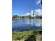 Scenic view of a tranquil lake surrounded by lush trees under a partly cloudy sky at 935 Shasta Rd, Venice, FL 34293