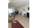 Inviting living room with tile floors, a decorative fireplace, and comfortable seating arrangement at 935 Shasta Rd, Venice, FL 34293