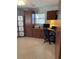 Home office with built in wooden desk and storage. Tile floor and a window for natural light at 935 Shasta Rd, Venice, FL 34293