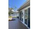 Inviting outdoor patio with sliding glass doors, ideal for enjoying the serene backyard at 935 Shasta Rd, Venice, FL 34293